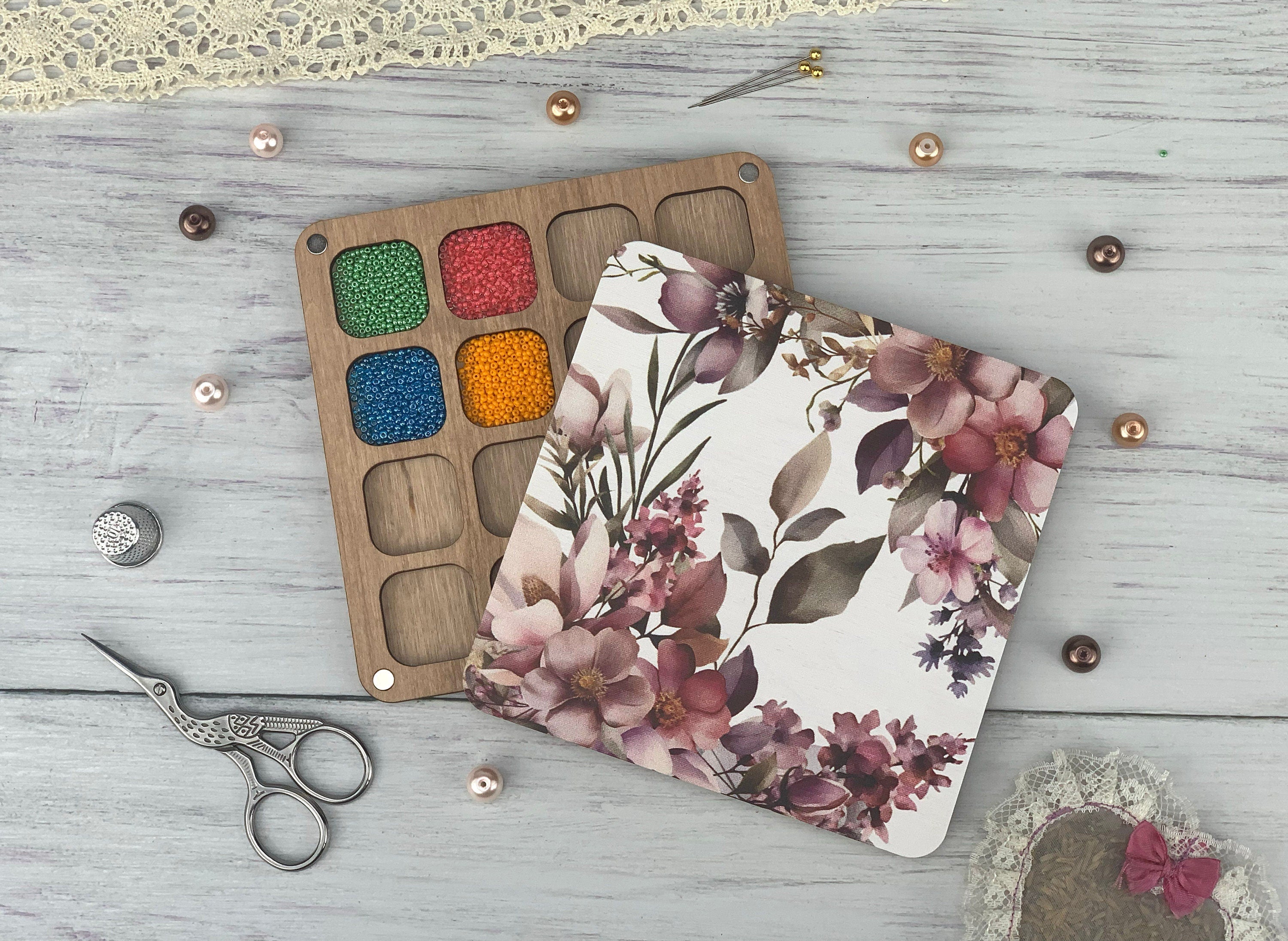 a pair of scissors and a palette of paint on a table